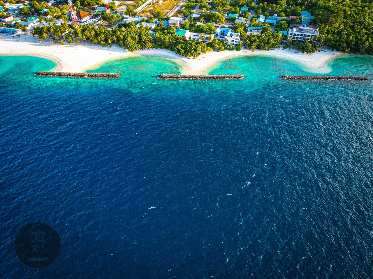 Panoramic aerial view of Dharavandhoo's white beaches, lagoon and coastal homes